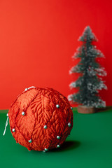 vintage red christams ball  and  xmas tree ornament decoration on green table with vivid red background.holiday celebration greeting card with copy space