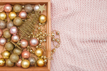Wooden tray with christmas decorations on warm knitted pink plaid. Xmas or New year concept. Top view Flat lay Copy space