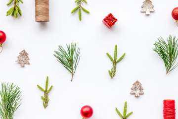 New Year background with fir branches and festive decoration on white table top view flat lay pattern
