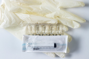 Medical gloves, ampoules, syringe.