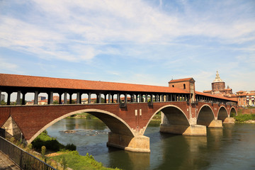 Fototapeta na wymiar Ticino River and the very old Covered Bridge in Pavia Town in It