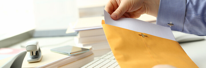 Fototapeta Businessman hold hand yellow mail envelope inbox post concept background obraz