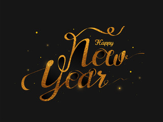 Fototapeta na wymiar Glittering calligraphy of Happy New Year on black background.