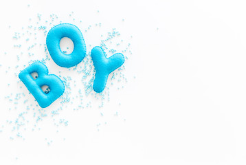 Boy word as decoration for baby shower on white background top view copy space