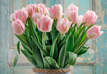 Bouquet of pink tulips on wooden background.
