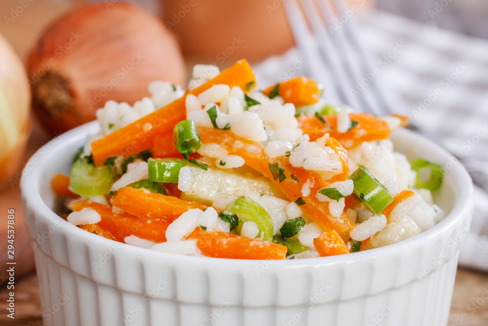 Canvas Prints Boiled rice with vegetables in a white ribbed bowl.