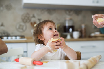 child toddler with dough and rolling pin, kitchen