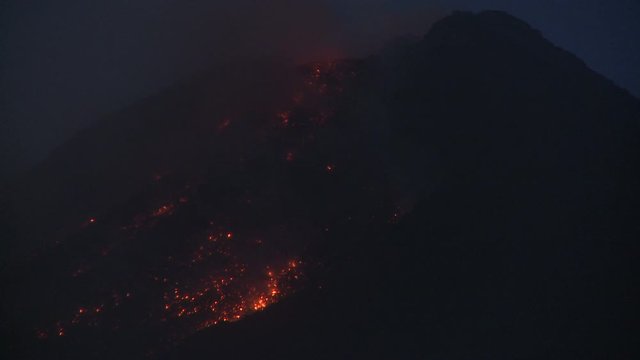 Lava Cascades From Erupting Mayon Volcano At Night