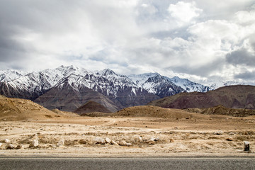 Leh Ladakh city view.  Beautiful amazing village in the valley with snow mountain at background. Ladakh, India.
