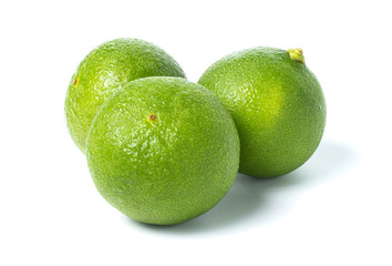 Fresh green lime with water drops isolated on white background with clipping path.