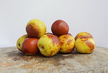 A group of jujube piled on a wooden table. Delicious asian fruit