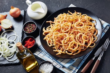 close-up of crispy fried onion rings and strings
