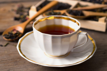 various types of tea on a wooden background