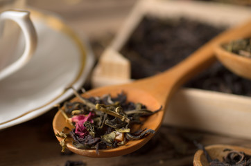 various types of tea on a wooden background