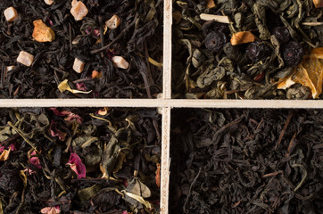 various types of tea on a wooden background