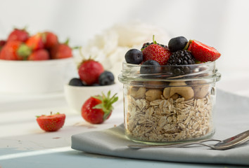 Healthy breakfast super food cereal concept with fresh fruit, granola, yoghurt