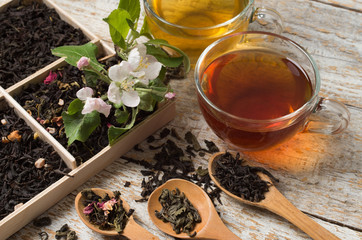 various types of tea on a wooden background