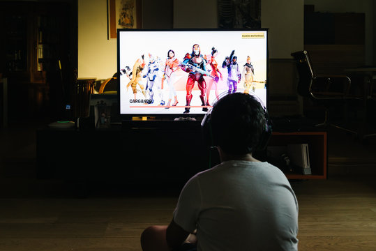 Teenager Playing Fortnite Video Game With PlayStation On TV