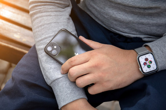 Man Hand With Apple Watch Series 5 Holding IPhone 11