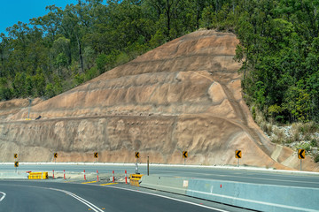 Protection Wall Cemented Into The Side Of a Mountain Beside A Highway