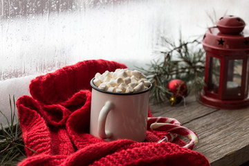 Cacao drink in a glass with marshmallow on the background of bokeh lights, window  Christmas hot drinks