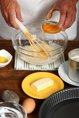 Making Sour Cream Lemon Cake. Adding Eggs into Batter.