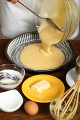 Making Sour Cream Lemon Cake. Pouring cake batter into baking tin.