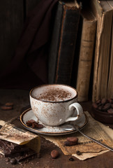 Hot chocolate - winter spicy drink in a brown cup on  wooden background.