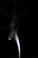 Smoke trail from candles lit from the side