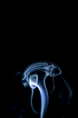 Smoke trail from candles lit from the side