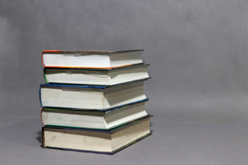 Stack of the books collection on grey background.