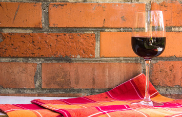 A  glass of red wine on a brick wall background