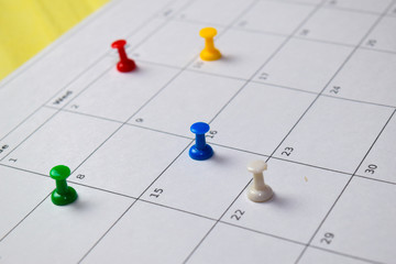 Close up Pinboard on white calendar. Schedule, reminder concept