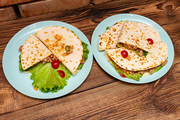fajitos with minced meat vegetables in a corn tortilla on a blue plate dark wooden background. fast food traditional food concept