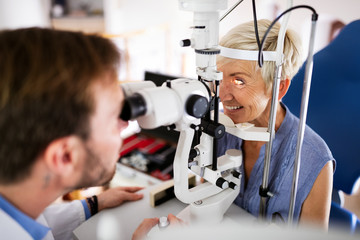 Fototapeta na wymiar Senior woman taking an eyesight test examination at an optician clinic