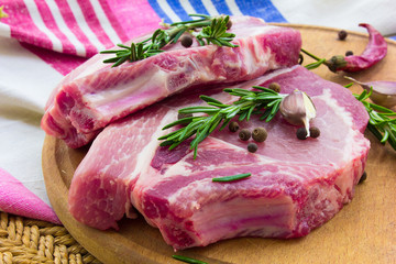 Raw beef sreak on a wooden board