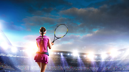 Young woman playing tennis on a stadium