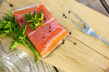 Fresh fish. Salmon. Raw salmon steak with sea salt pepper and herbs. Food background.