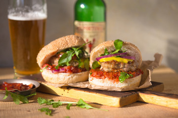 Burger flyer. Cheese burger with grilled meat, cheese, salad and onion rings. Close-up of delicious fresh home made burger on concrete brick background