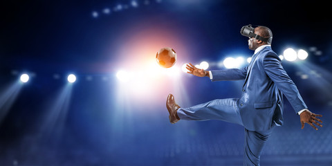 Black businessman on virtual reality football match