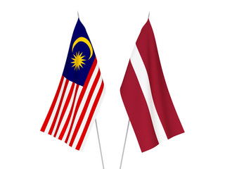 National fabric flags of Latvia and Malaysia isolated on white background. 3d rendering illustration.