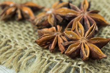 Heap of anise stars, isolated on wooden background