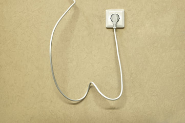 Body lines. A white electric wire to the plug with a socket hangs in the lobby of the cream-colored Vanilla Custard wall, resembling the bends of the human body.