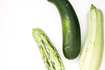 Summer harvest of vegetables concept. Zucchini on a light white background.