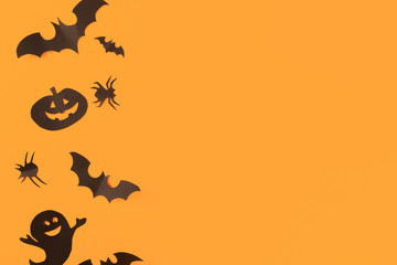 Halloween paper decorations on orange background. Halloween concept. Flat lay, top view, copy space - Image