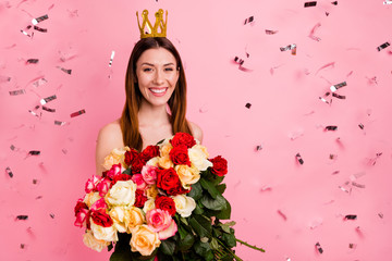 Close-up portrait of her she nice-looking attractive lovely cheerful cheery glad girl holding in hands big large bouquet many different rose stem wearing crown isolated on pink pastel color background