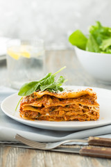 Traditional Homemade Italian Lasagna with Tomato Sauce Isolated on White Background. Hot Tasty Lasagna or Lasagna with Parmesan Cheese on Elegant Restaurant Plate Close Up