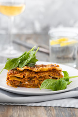 Traditional Homemade Italian Lasagna with Tomato Sauce Isolated on White Background. Hot Tasty Lasagna or Lasagna with Parmesan Cheese on Elegant Restaurant Plate Close Up