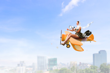 Woman in retro airplane . Mixed media