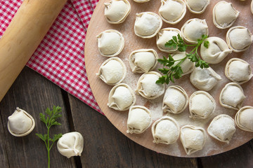 Raw Russian dumplings on the cutting board. 